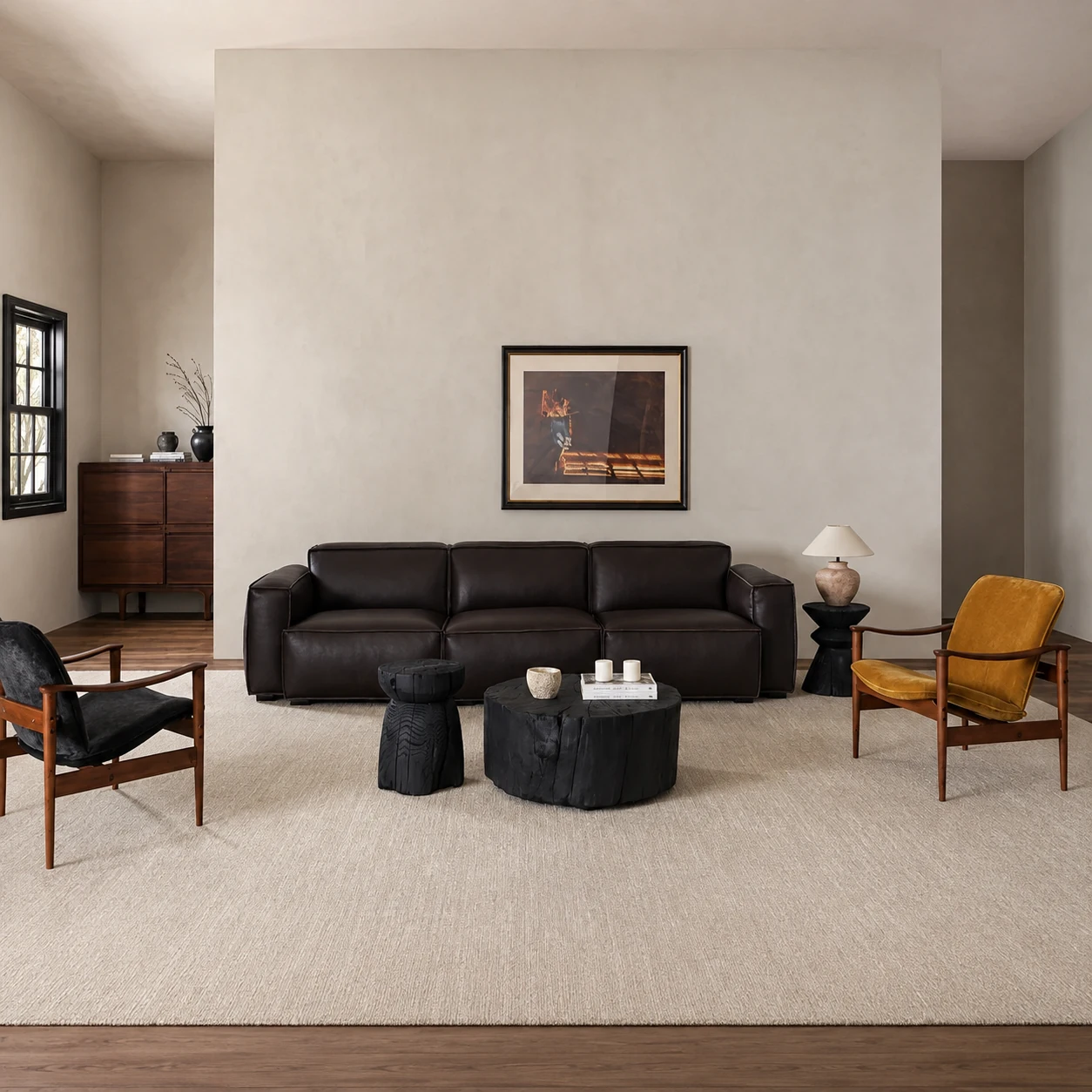 Dark leather Kaku sofa arranged with low charred timber objects