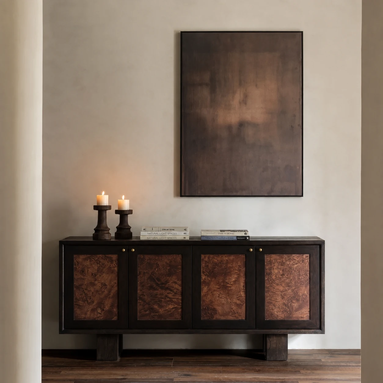 Dark timber Kobu sideboard with figured burl doors beneath abstract artwork