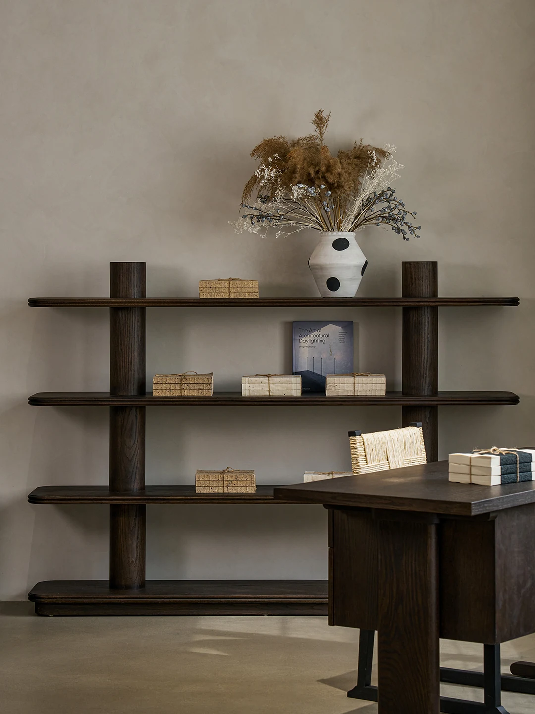 Open dark timber Tana shelving styled with books and ceramics