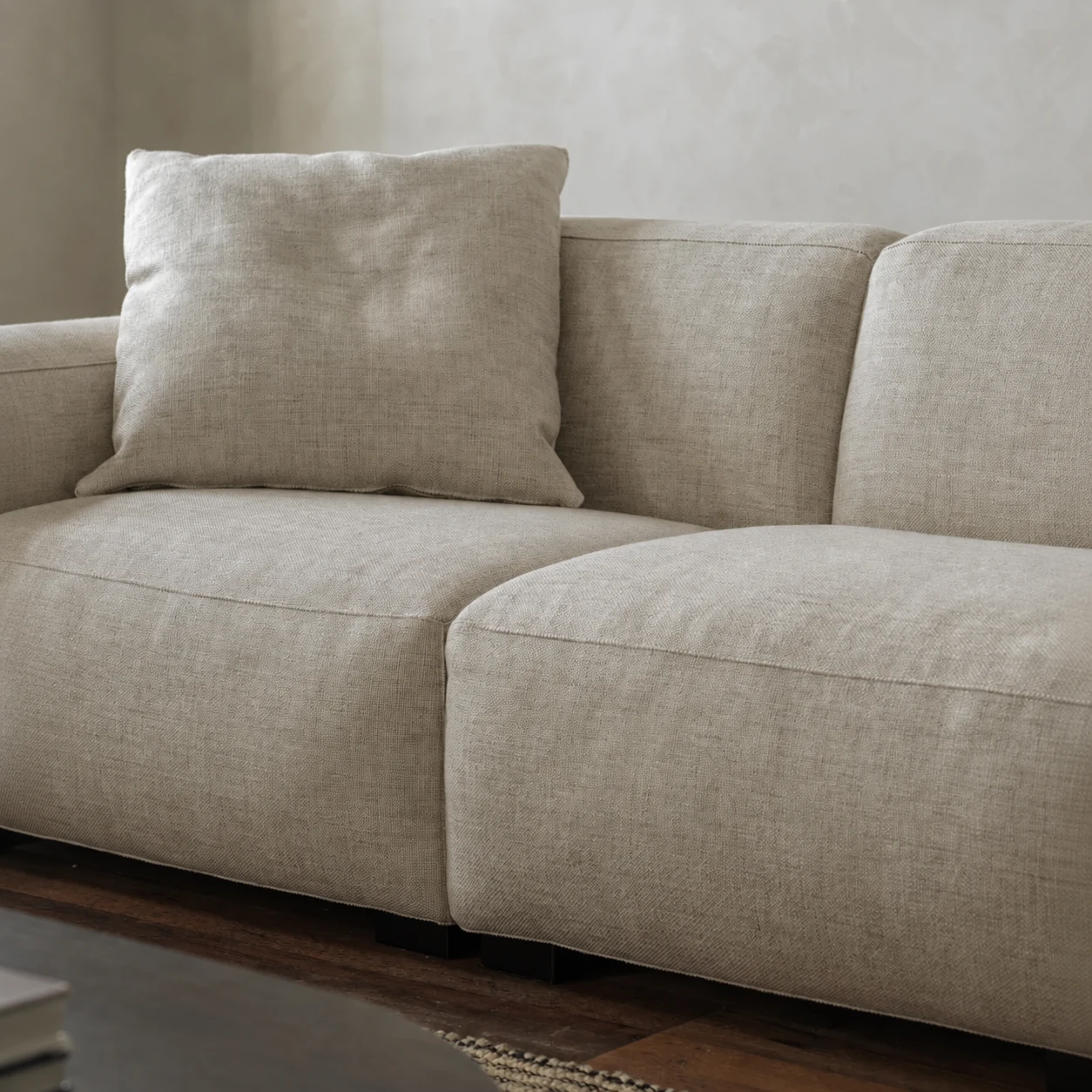 Close detail of Kaku sofa seat modules and woven cream upholstery