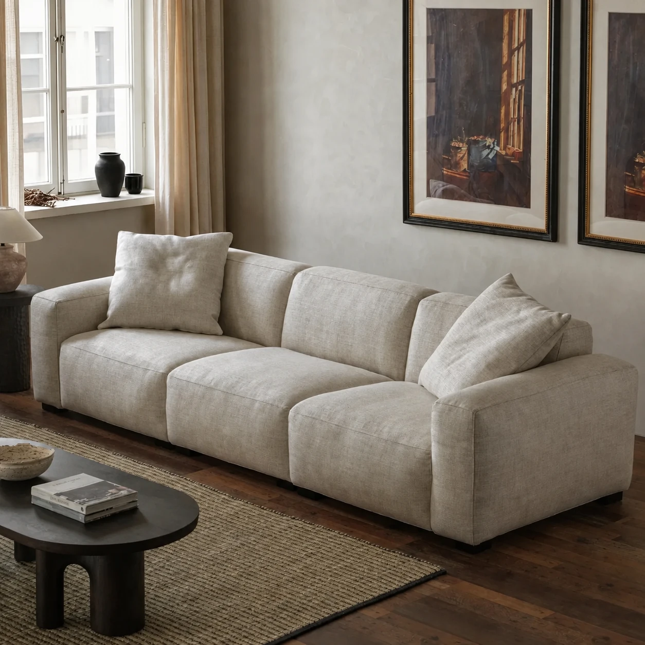 Three-quarter view of the cream Kaku sofa in a softly lit residential interior